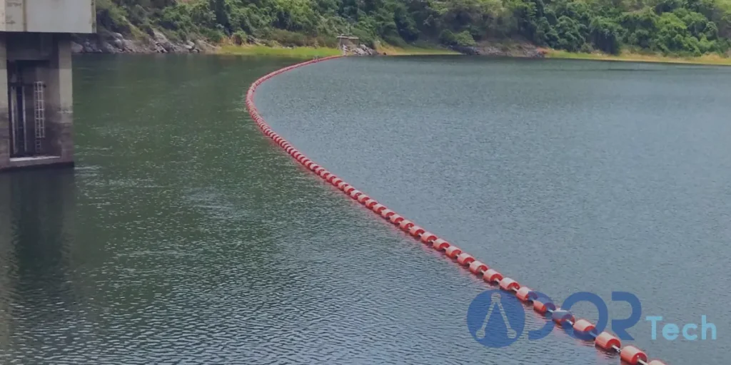 HDPE floating barrier installed across a calm water reservoir to protect infrastructure and ensure environmental safety.