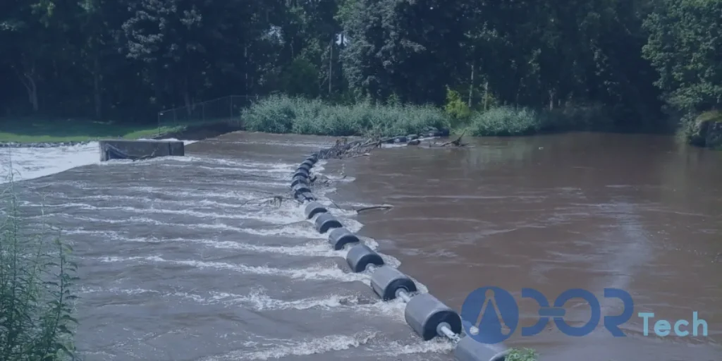 Heavy-duty HDPE boom installed across a fast-flowing river to block debris and ensure safe waterway management.
