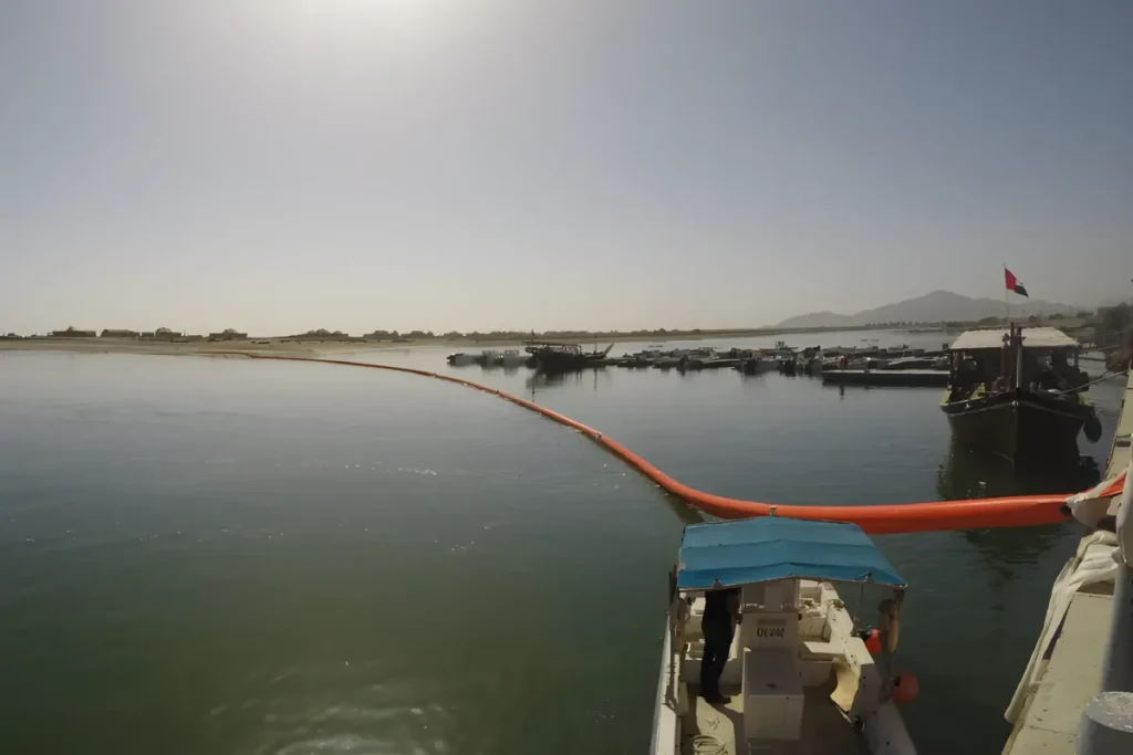 Inflatable oil boom deployed in harbor water