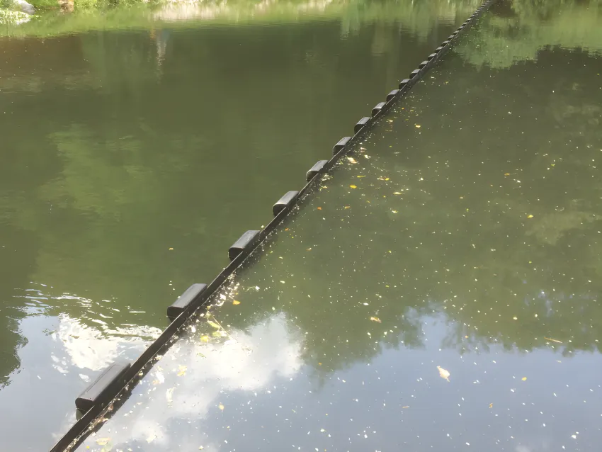 Floating debris boom separating debris in a waterway
