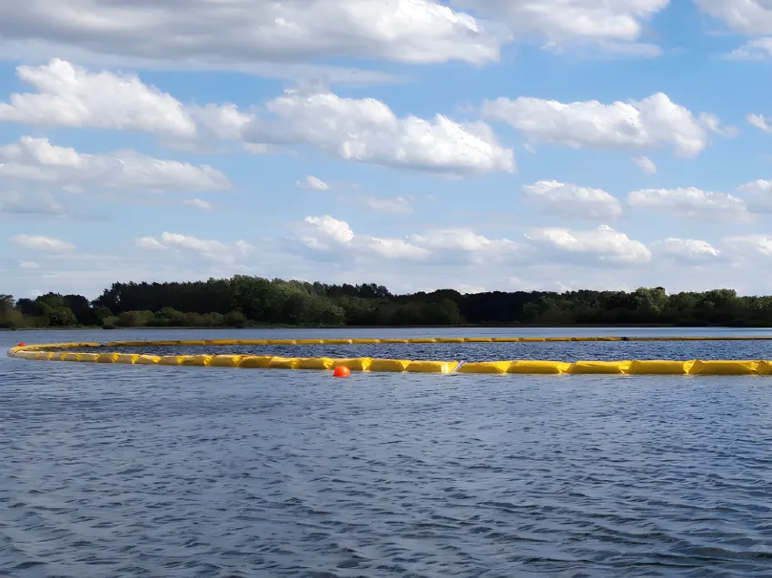 Floating oil containment boom installed on water for spill control
