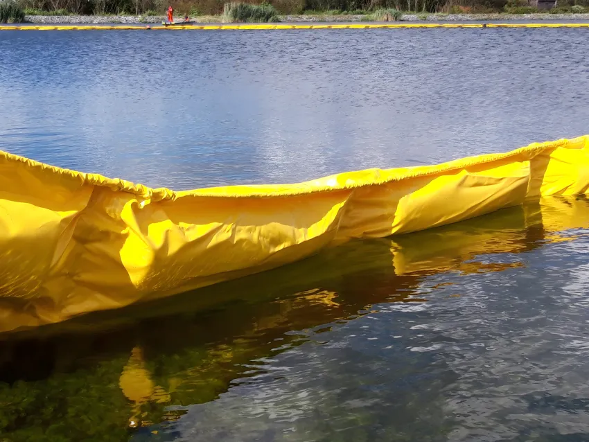 Oil containment boom floating on inland water for spill control