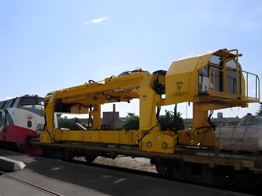 Railway gantry carrying sleepers for track work.